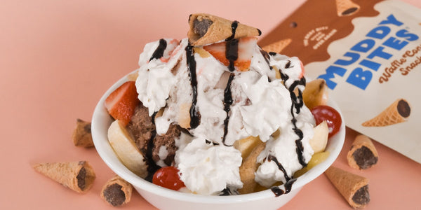 Banana split garnished with Muddy Bites for extra crunch.