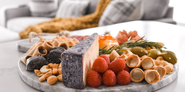 Photo of a snack plate featuring Muddy Bites, with a cozy couch in the background.