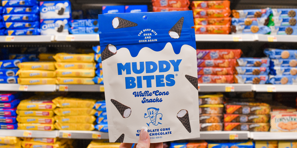 Package of Muddy Bites displayed on a grocery store shelf, with other snacks in the background.